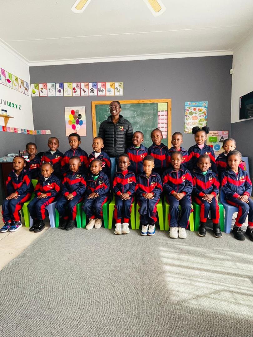A class with their teacher at Babies and Todd's Academy