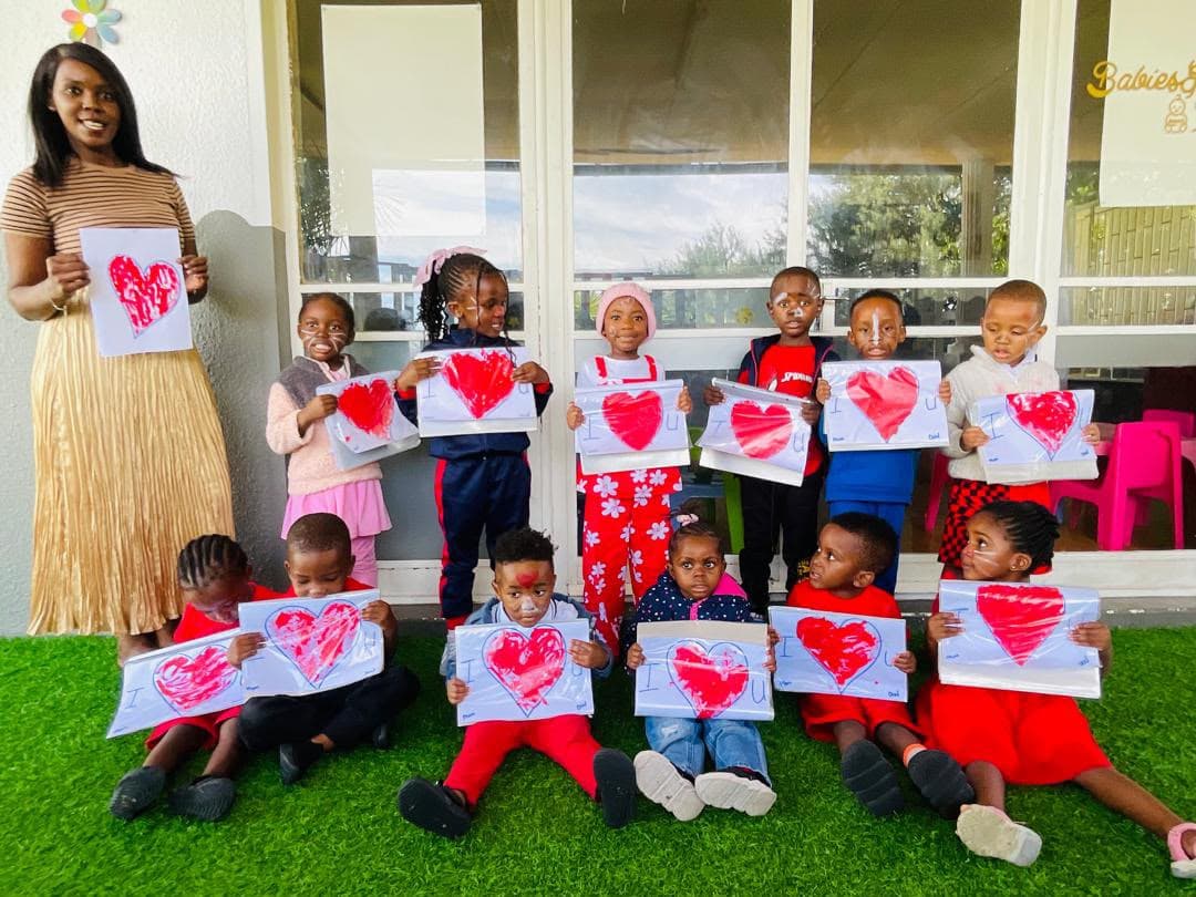 Children proudly sharing artwork made at the academy