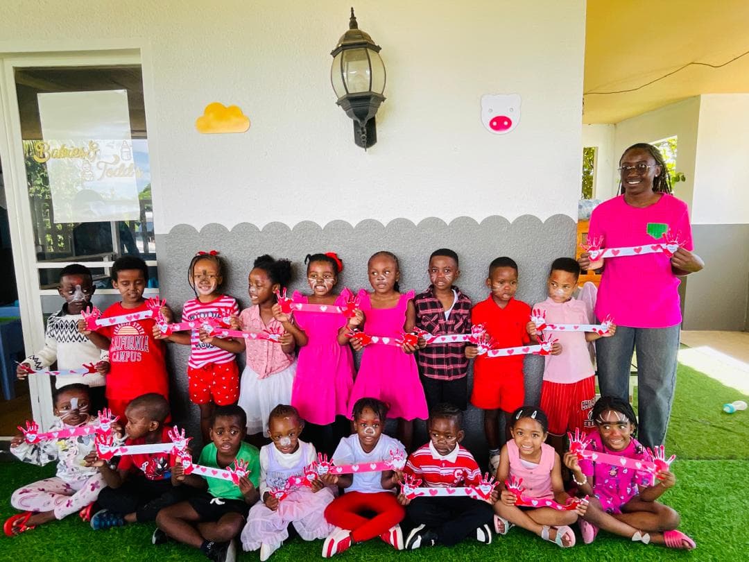 Children and their teacher celebrating together at Babies and Todd's Academy
